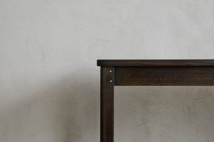 Close up of the top corner of Oxidized Oak Lore Console