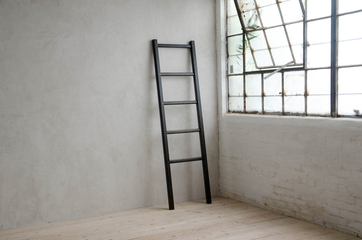 Oxidized Oak Ladder leaning again a concrete wall