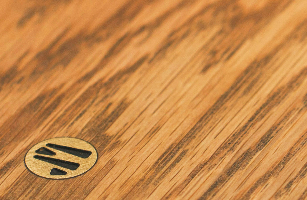 Close up of Brass JM Logo in White Oak Wood