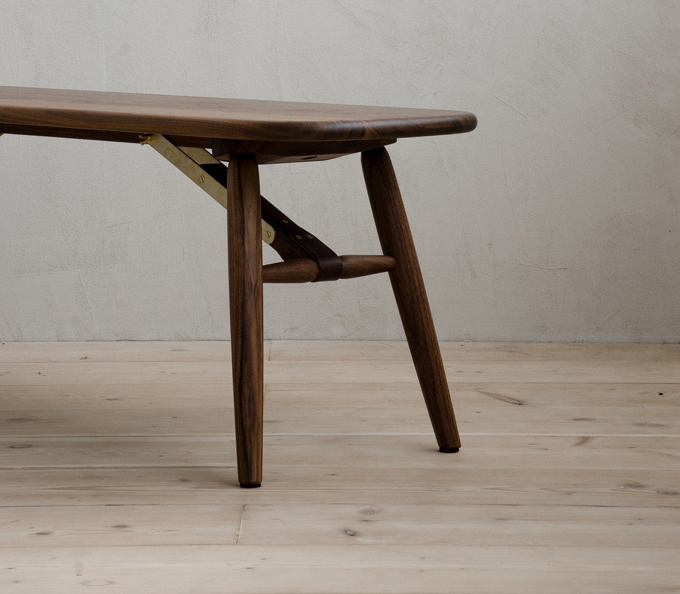 Closeup of The End of Nomad Bench with Brass Features