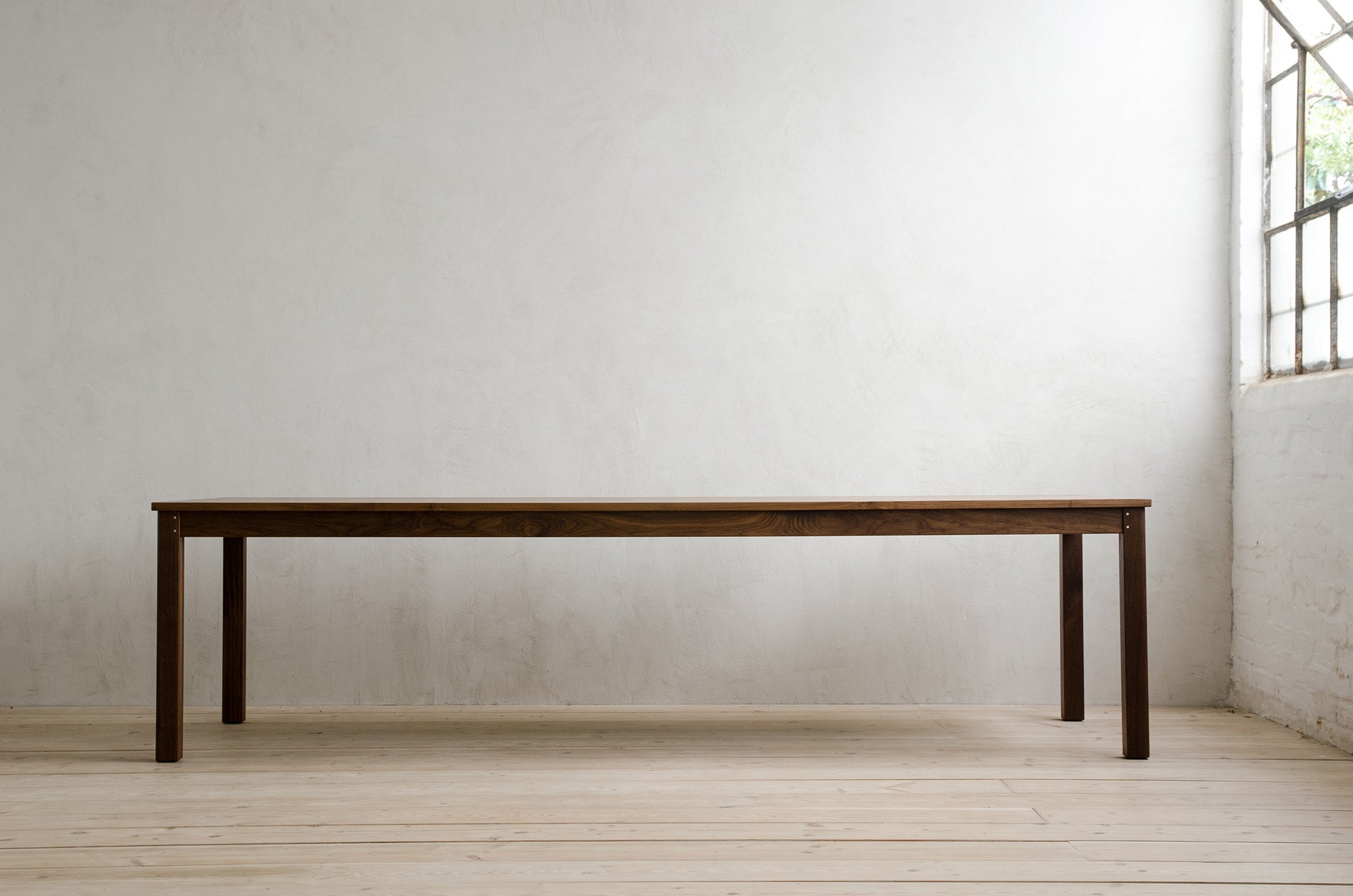 Natural Walnut Lore Dining Table in Empty Modern Room