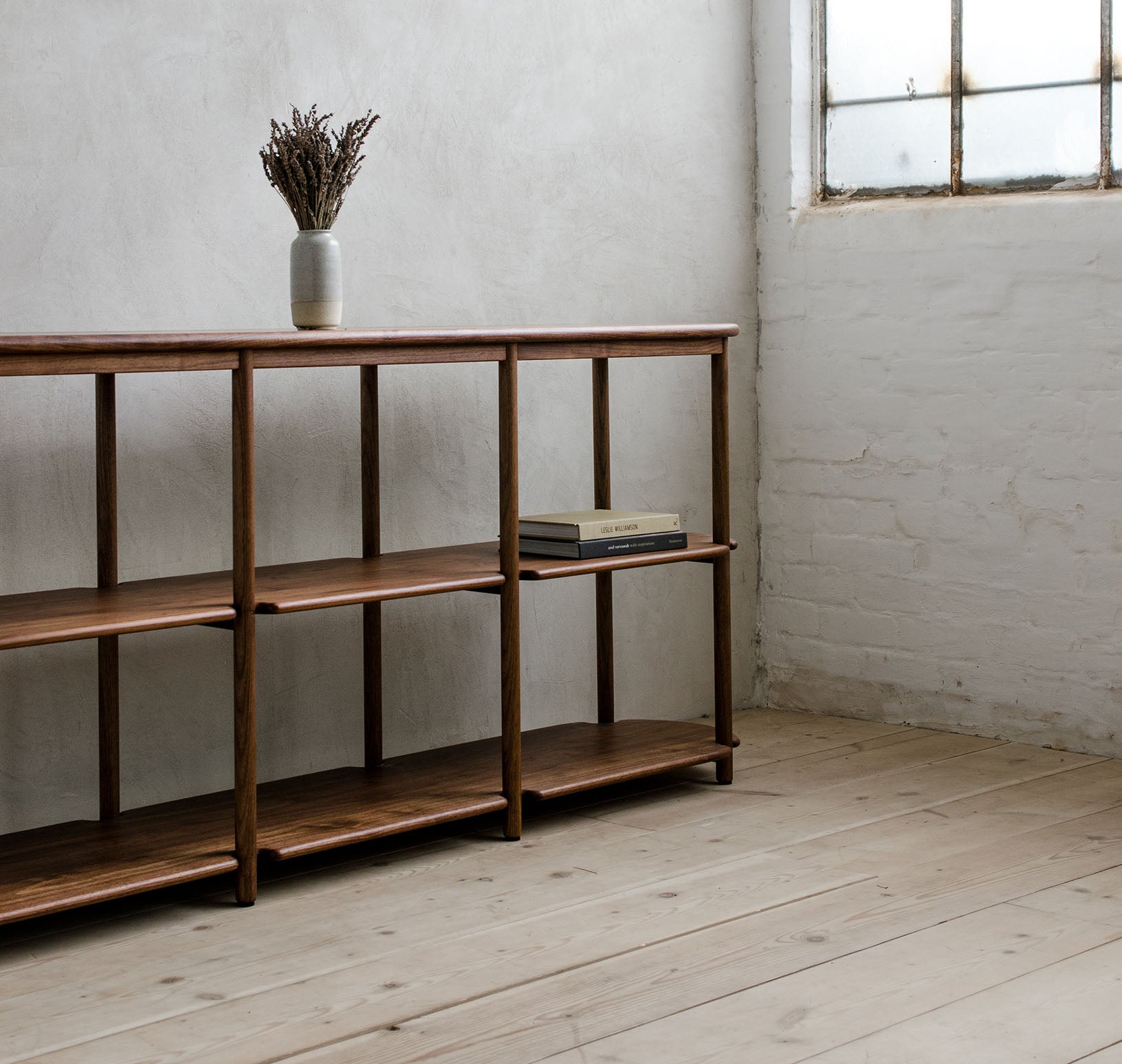 Scribe Bookshelf with Books and Flowers on Top