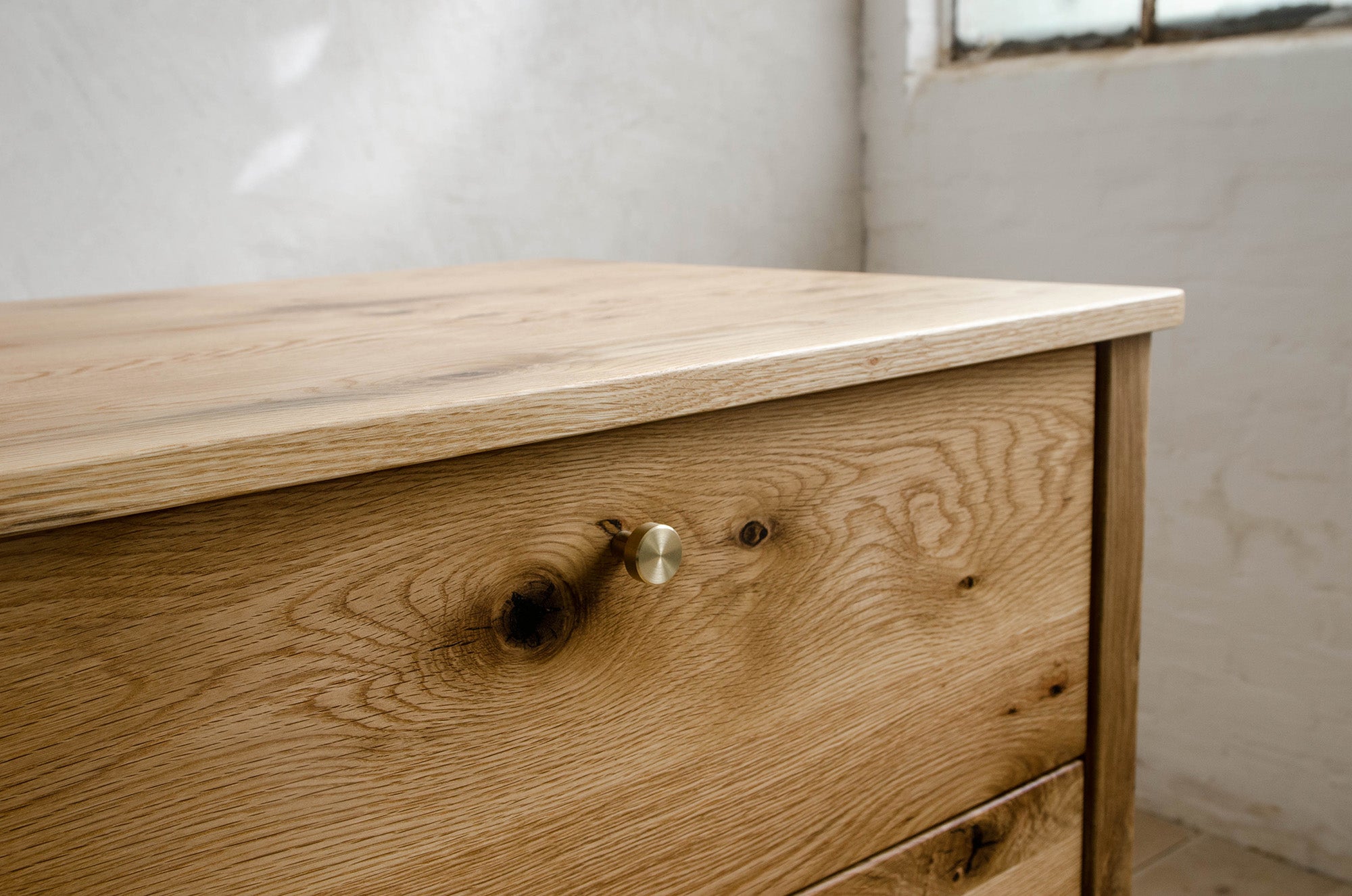 Closeup of Drawer And Brass Knob in Natural White Oak