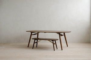 Nomad Rectangular Dining Table with Brass Features on Top of Nomad Bench