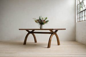 Inyo Dining Table in Natural Walnut With Vase of Flowers on Top